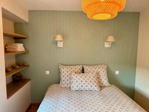 a bedroom with a bed with two pillows on it at Gîte du Pavillon 4 pers Wi-Fi Haute Marne in Arc-en-Barrois