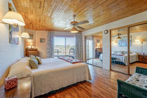 a bedroom with a bed and a ceiling fan at Wild Bill Retreat Treehouse Acre of Fun Near Grand Canyon Williams in Williams