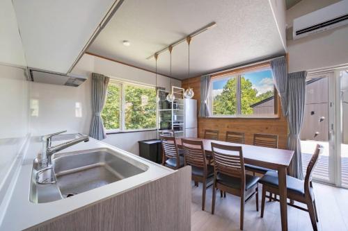 a kitchen with a sink and a table with chairs at NISEKO Mt,Village - Vacation STAY 65414v in Kaributo