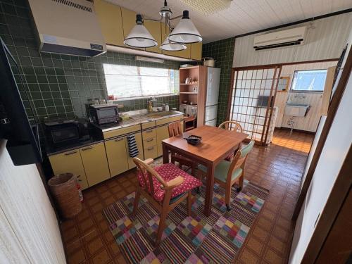 a kitchen with a table and chairs in a kitchen at Kohaku - Vacation STAY 20499 in Nagahama