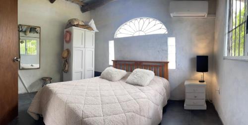 a bedroom with a bed with two pillows on it at Casa en punta N a 12 minutos de Piriapolis in Punta Colorada