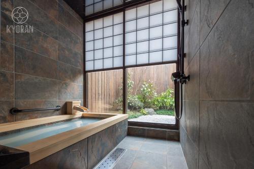 ein Badezimmer mit Badewanne und großem Fenster in der Unterkunft Kyoran [Shion Residence] - Vacation STAY 69064v in Kyōto