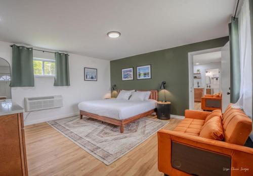 a bedroom with a bed and a couch at The Inn at Shady Pines in Gros Cap