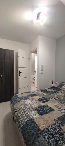 a bedroom with a bed and a mirror at La 62 du 11 11 in Bourbourg