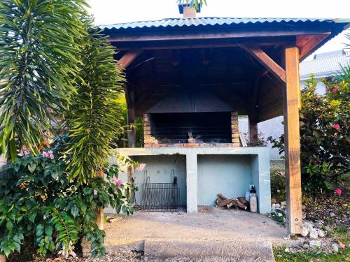 a dog laying under a pavilion with a dog laying down at Iguane Bungalow in Saint-François