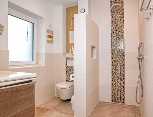 a bathroom with a toilet and a shower at Glück Ahoi in Insel Poel