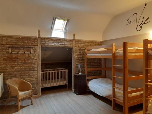 a room with two bunk beds and a desk at L'Ecole in Dinant