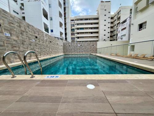 a swimming pool in the middle of a building at Hotel Chayrama in Santa Marta