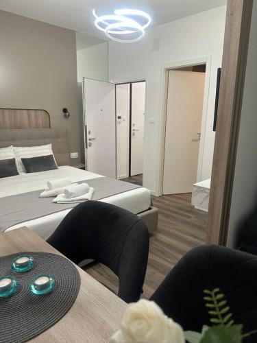 a bedroom with two beds and a table with chairs at Harmony in Trieste
