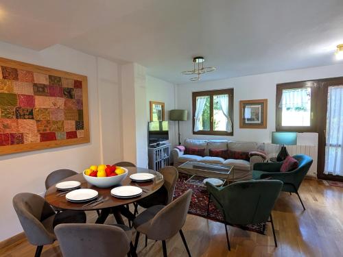 a living room with a couch and a table and chairs at Casa Pilar Escarrilla Ski Views Parking Children Games Room in Escarrilla