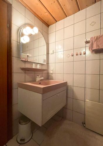 a bathroom with a sink and a mirror at Neuhaus Apartments in Gosau