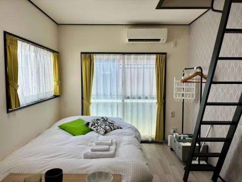 ein Schlafzimmer mit einem Bett mit einer Leiter und einem Fenster in der Unterkunft Corpo SKR201 - Vacation STAY 20556 in Kichijōji