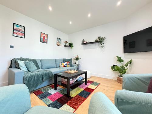a living room with a blue couch and a table at Modern Apartment, Central Brighton Breakaway - Friends, Families, Work in Brighton & Hove