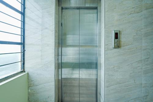 une porte vitrée sur le côté d'un bâtiment dans l'établissement Hotel O Thanisandra Railway Station Formerly Urban Drift, à Yelahanka