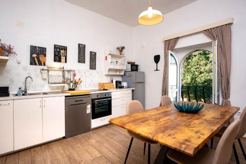 a kitchen with a wooden table and a dining room at Apartment Julietta in Rab