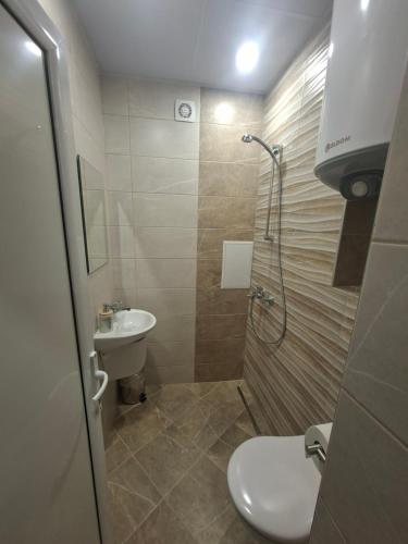 a bathroom with a shower and a toilet and a sink at Number 1 in Ruse