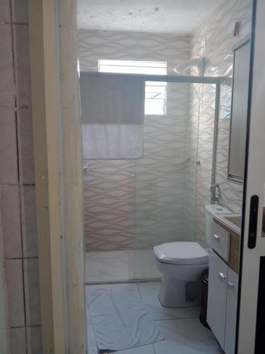 a bathroom with a shower with a toilet and a sink at apartamento 301 in Florianópolis