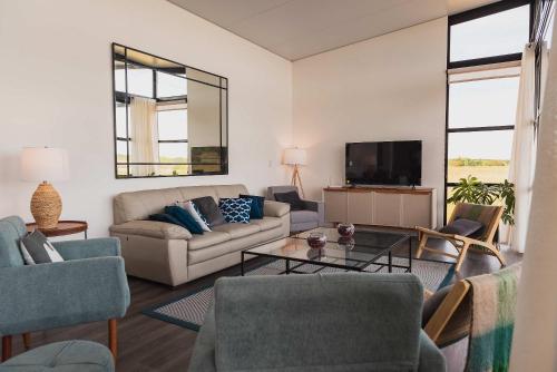 a living room with a couch and a tv at Carmelo Golf by Puerto Dijama in Colonia Estrella