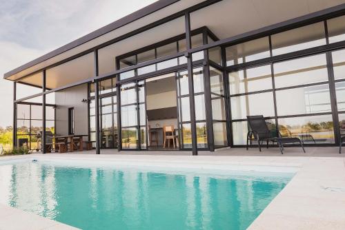 a house with a pool in front of it at Carmelo Golf by Puerto Dijama in Colonia Estrella