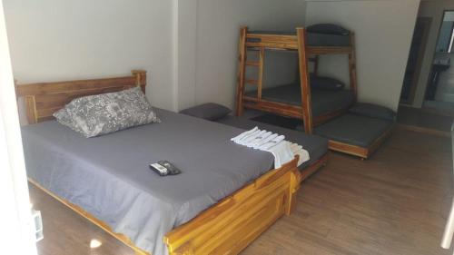 a bedroom with a bed with a remote control on it at hotel salome in Puerto Triunfo