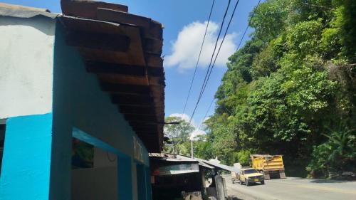a truck driving down a street next to a building at hotel salome in Puerto Triunfo