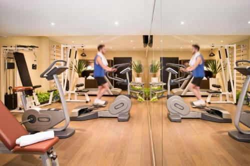 a man running on a treadmill in a gym at Starhotels Tourist in Milan