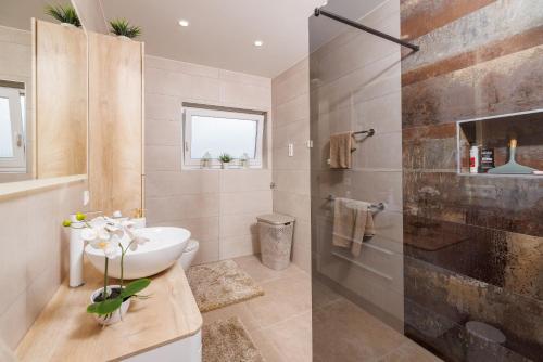 a bathroom with a sink and a shower at Apartments San in Dramalj