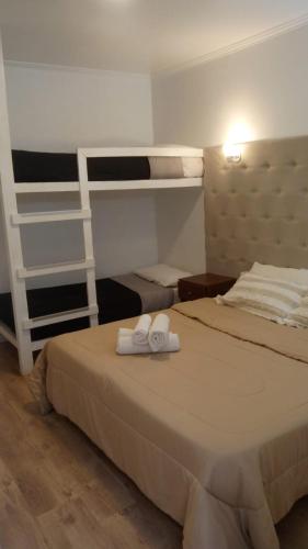 two beds in a room with two bunk beds at HOTEL RESTAURANTE Ruta 66 in Paso de los Libres