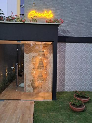 a building with a window with lights in it at Carambola CoLiving in Olinda