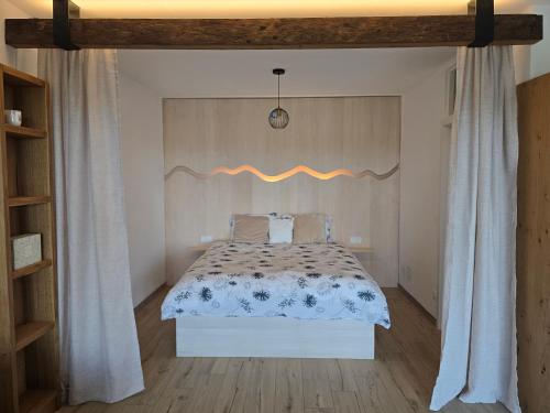 a bedroom with a bed and a wooden floor at Bellevue relax Apartment in Žetale