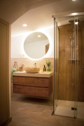 a bathroom with a sink and a mirror at El Charcon Alojamiento Rural in El Chorro