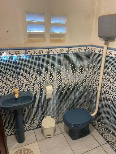 a bathroom with a blue toilet and a sink at Casa Maria Bonita in Aracati