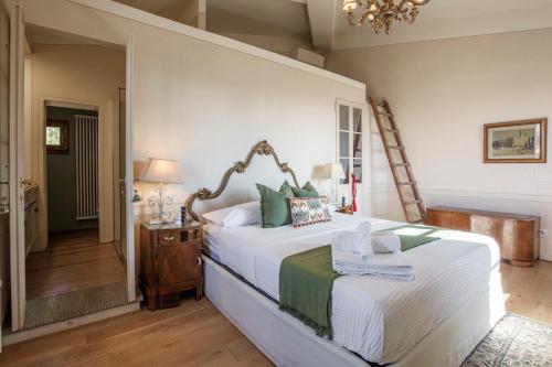 Un dormitorio con una cama grande con una lámpara de araña. en Villa Ridente - Elegance and views of Florence, en Settignano