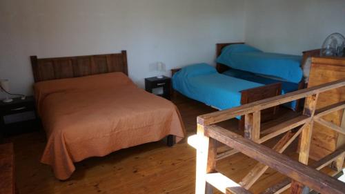 a small bedroom with a bed and a couch at Cabañas La Sarita in La Consulta