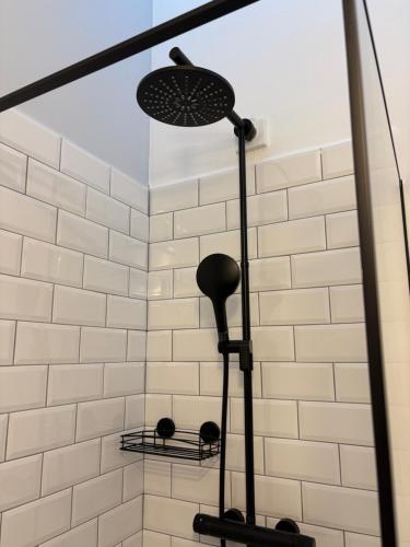 a shower with a shower head and two shelves at Villa Claus in Puerto Calero