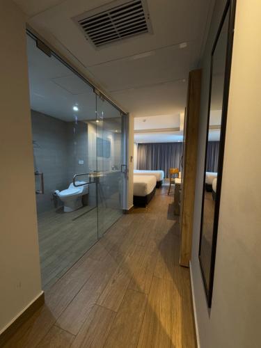 a room with a glass door leading to a bedroom at Wyndham Garden Cartagena in Cartagena de Indias