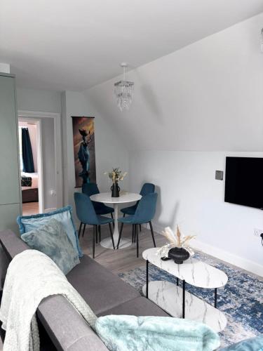 a living room with a couch and a table at Castle-View Apartment & Free Parking on Site in Dover