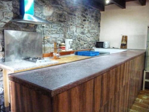 a kitchen with a large counter top in a room at Casa La Farrapona de Babia in Torrestío
