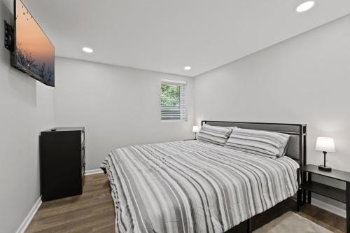 a bedroom with a large bed with white walls at Exceptional Willowbrook Retreat in Willowbrook