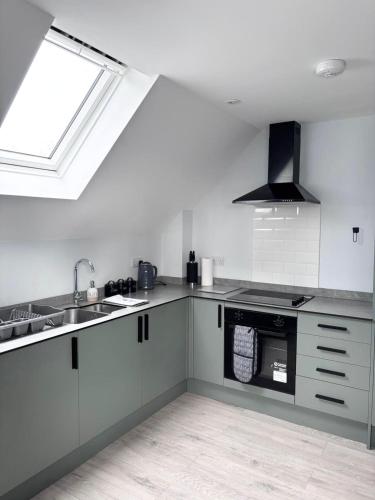 a kitchen with a sink and a stove at Castle-View Apartment & Free Parking on Site in Dover