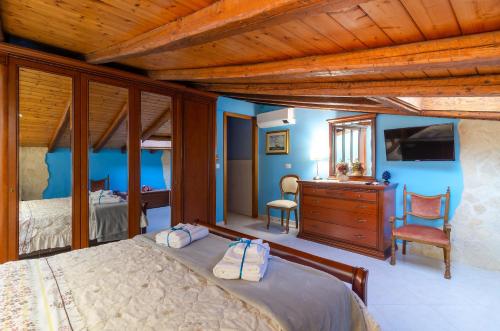 a bedroom with a bed and a dresser and a desk at Casa delle Zammare Fronte mare centro storico in Riposto
