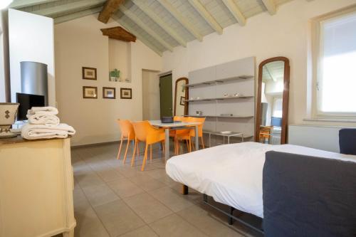 a bedroom with a bed and a table and chairs at Piacenza centro in Piacenza