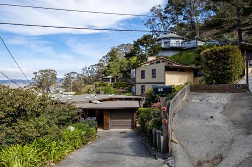 a house on the side of a hill at Small Home with Ocean View walk to Restaurants Brewery Shops Beach in Pacifica