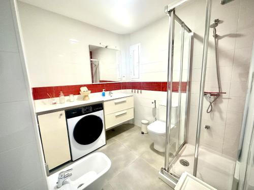 a bathroom with a toilet sink and a shower at Costamar Infinite Sea Views by Deihu Experiences in Los Cristianos