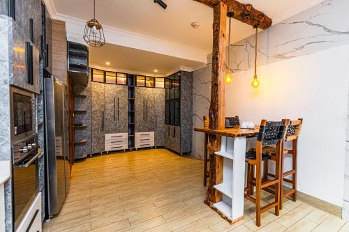 a tasting room with a bar in the middle of the room at The Crest Apartment in Kigali