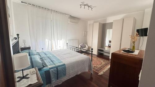 a bedroom with a bed and a dresser and a window at Salseadine - Senigallia in Marzocca di Senigallia