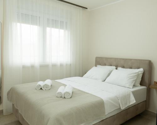 a bedroom with a bed with towels on it at Sirmium stay in Sremska Mitrovica