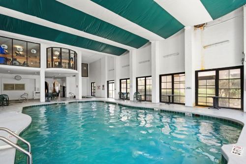 an indoor pool with blue water in a building at Palms Resort 905- Oceanfront in Myrtle Beach