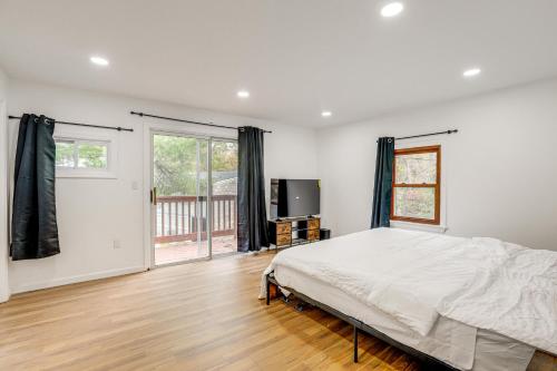 a bedroom with a bed and a large window at Updated Getaway with Sauna and Yard in Bloomsbury! in Port Warren