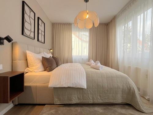 a bedroom with a bed with two stuffed animals on it at Seestadt Apartment I Sauna I Parkplatz I Zentral in Haltern